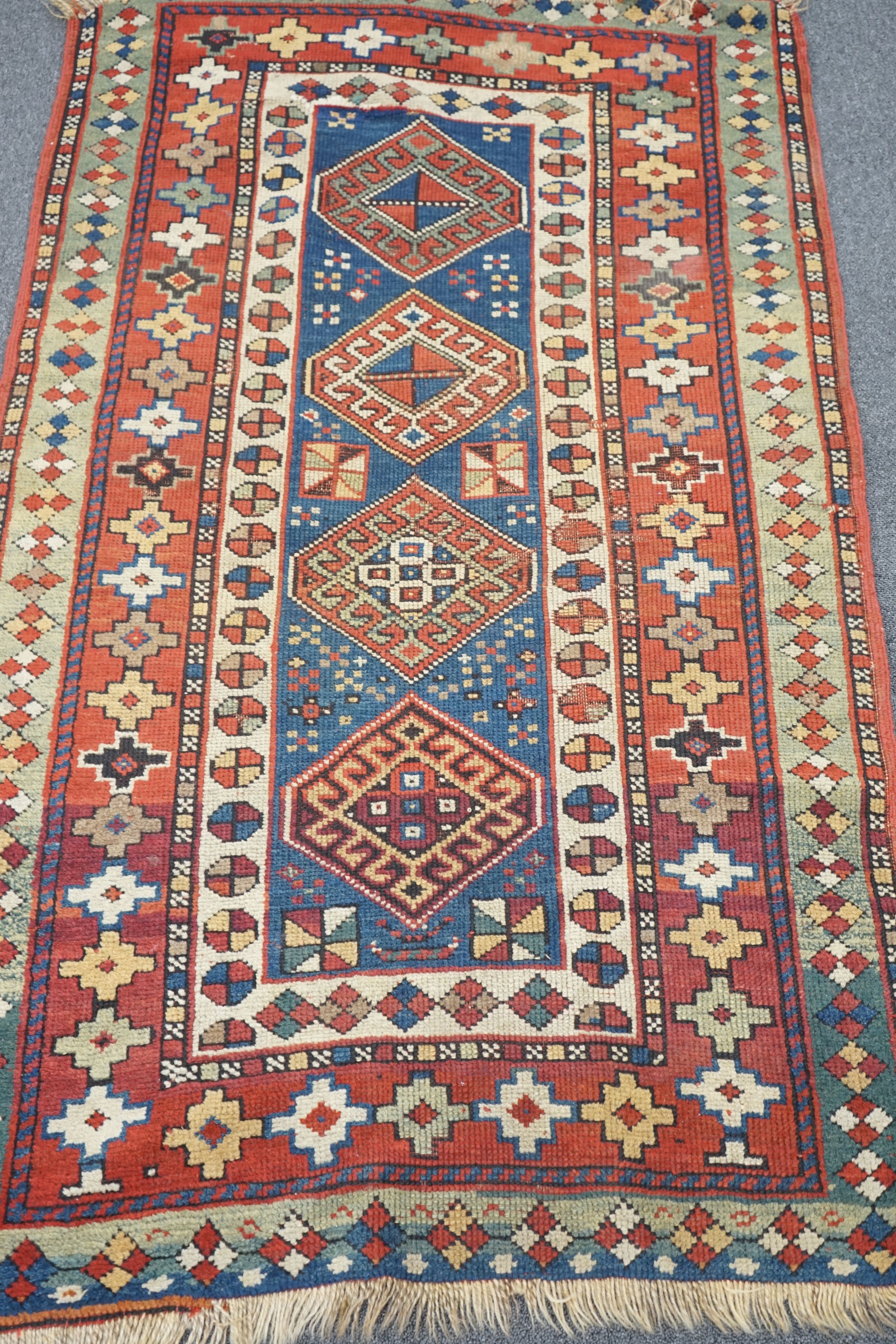 A Kazak blue ground rug, 152 x 95cm